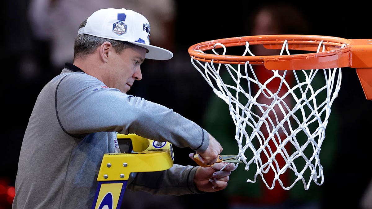 Dusty May cuts down the nets