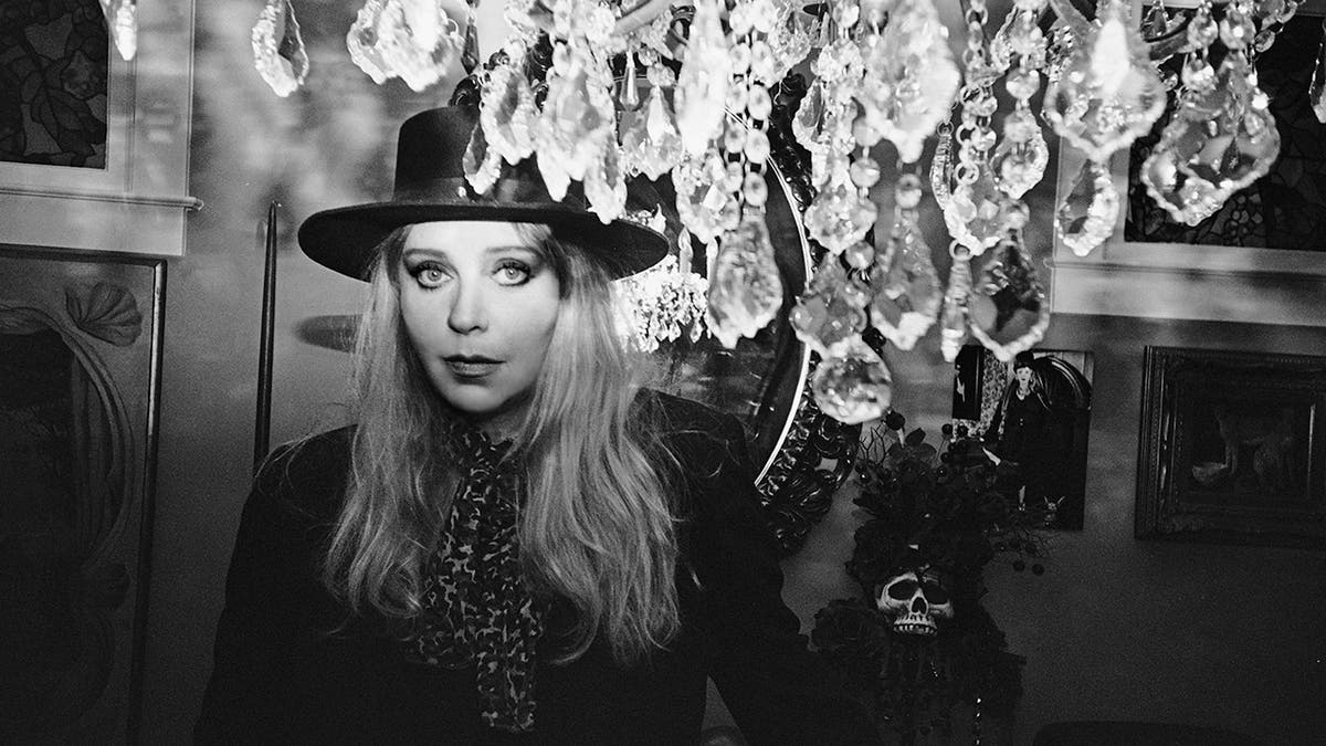 Bebe Buell photographed with a chandelier