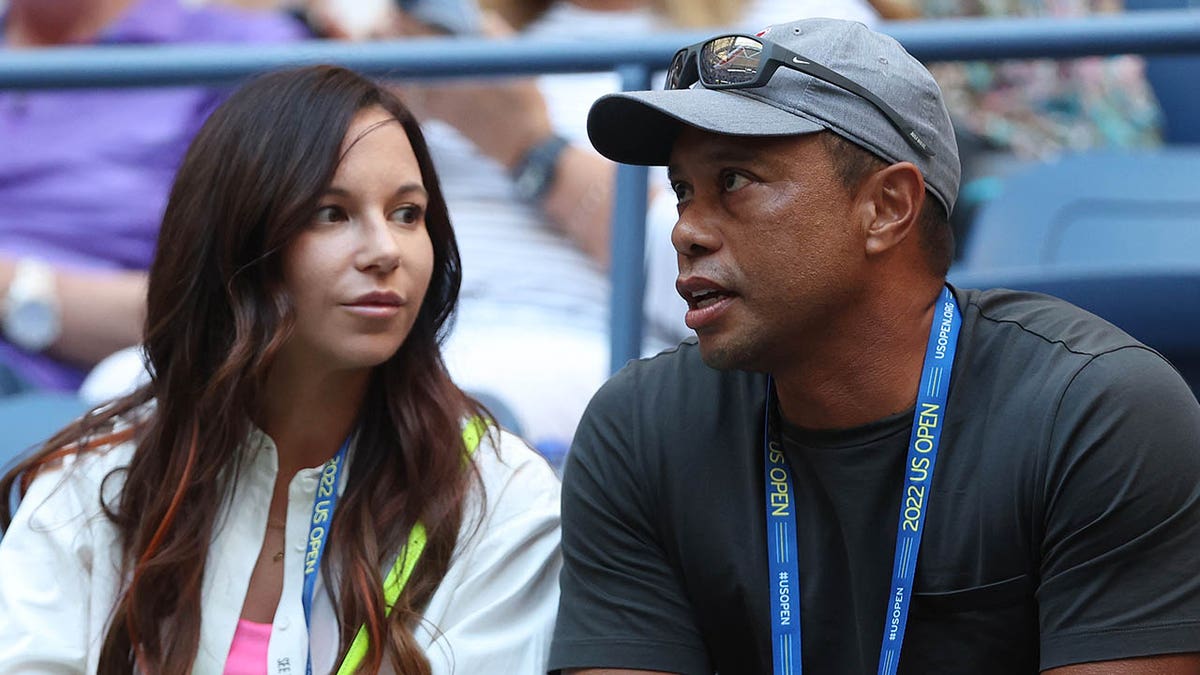 Tiger Woods talks with Erica Herman