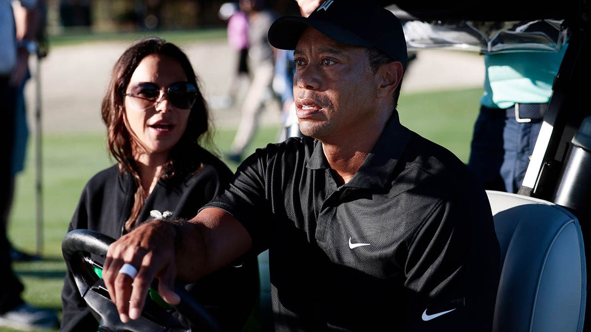 Tiger Woods drives Erica Herman