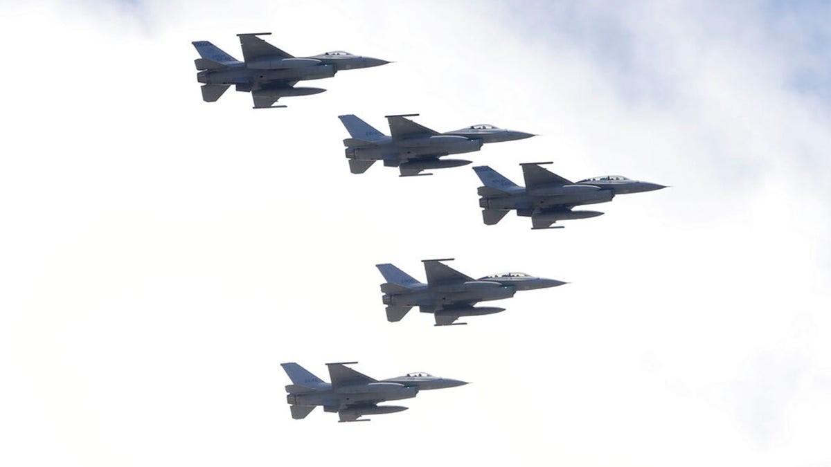 FILE: Taiwan's F-16 fighter jets fly in close formation over President Office during National Day celebrations in front of the Presidential Building in Taipei, Taiwan, Oct. 10, 2021. 