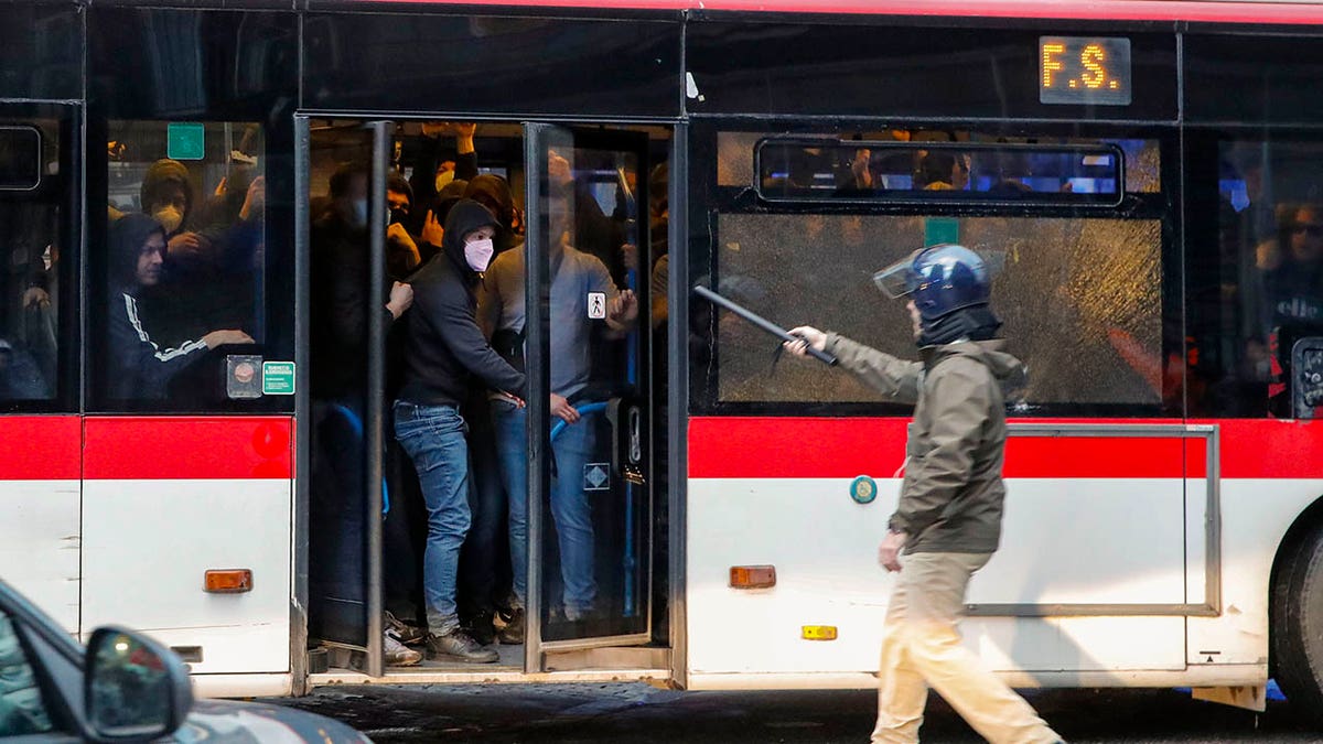Fans pile into a bus