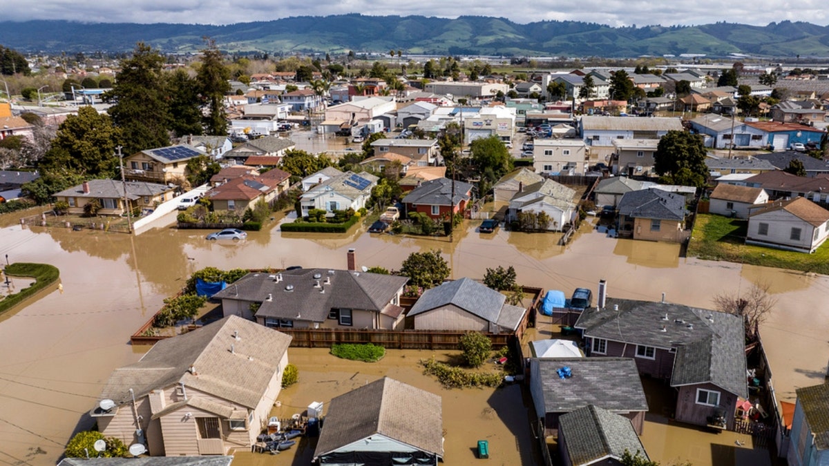 Floodwaters surround homes and vehicles in Pajaro
