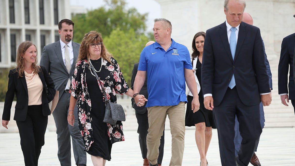 Football coach Joe Kennedy walks near the Supreme Court