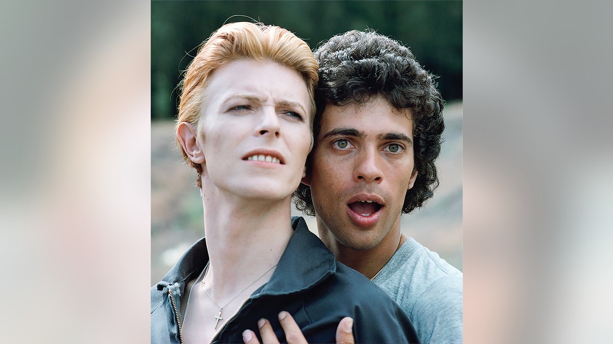 Geoff MacCormack embracing David Bowie for a posed humorous photo