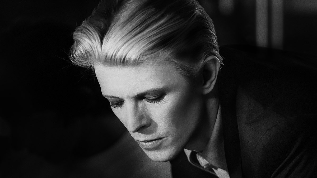 A black and white close-up photo of David Bowie