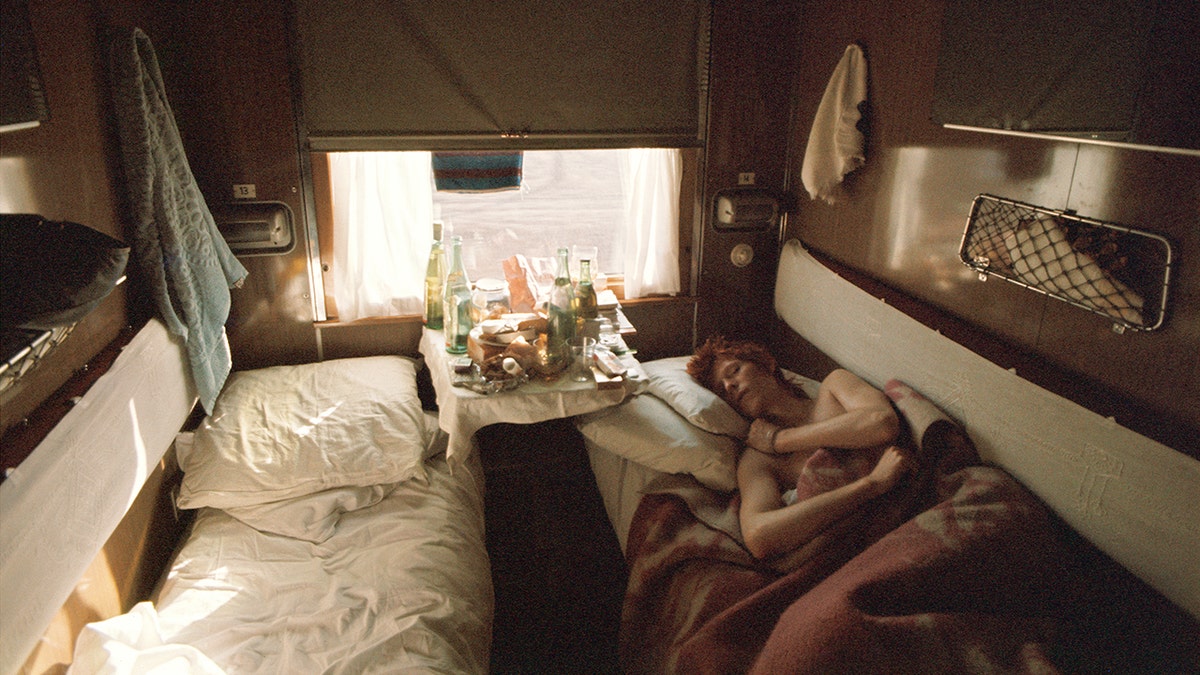 David Bowie sleeping in a hotel room.