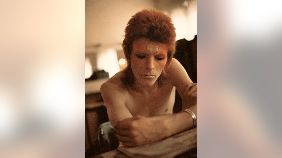 David Bowie looking away from the camera as Ziggy Stardust