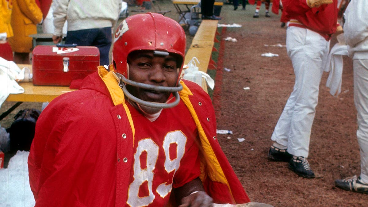 Chiefs wide receiver Otis Taylor sits on an NFL sideline in the 1970s