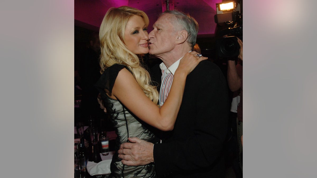 Hugh Hefner gives Paris Hilton kiss