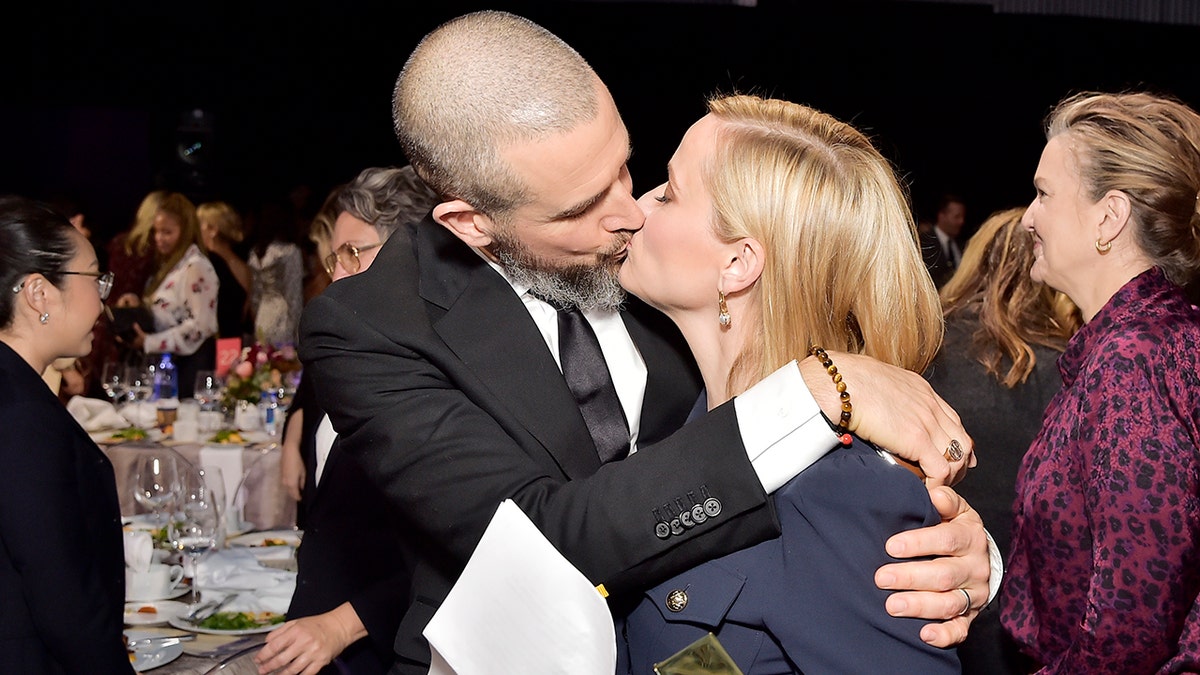 Jim Toth and Reese Witherspoon kissing at The Hollywood Reporter's Power 100 event in 2019