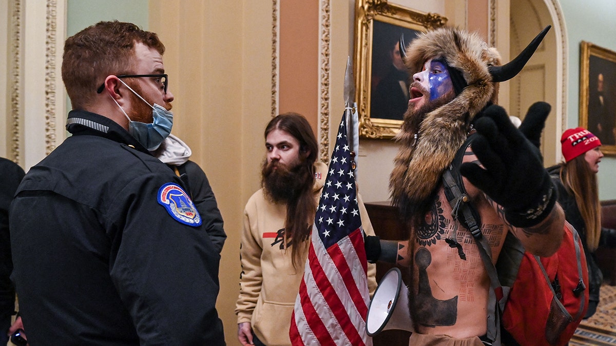 An officer and others in the Capitol