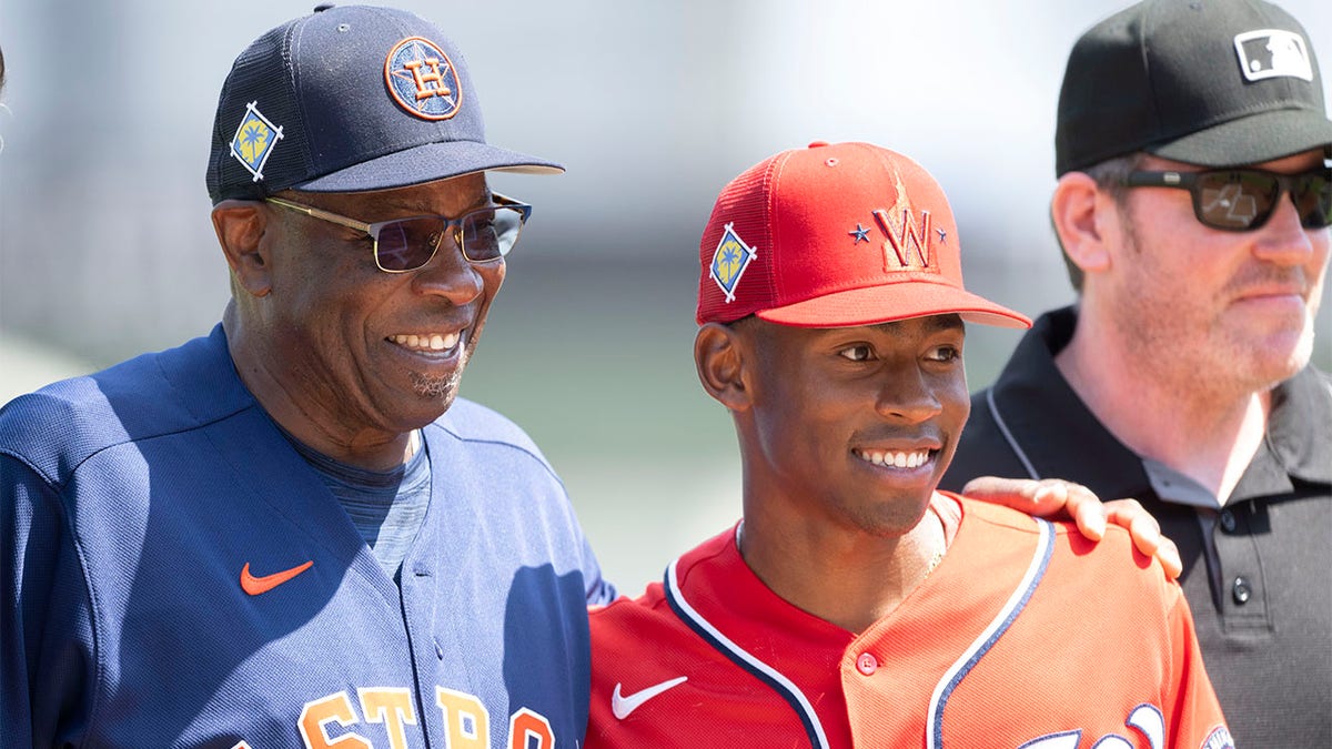 Dusty Baker and his son pose with a picture