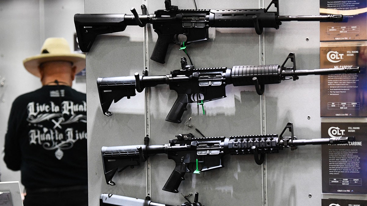 Colt M4 Carbine and AR-15 style rifles on wall display