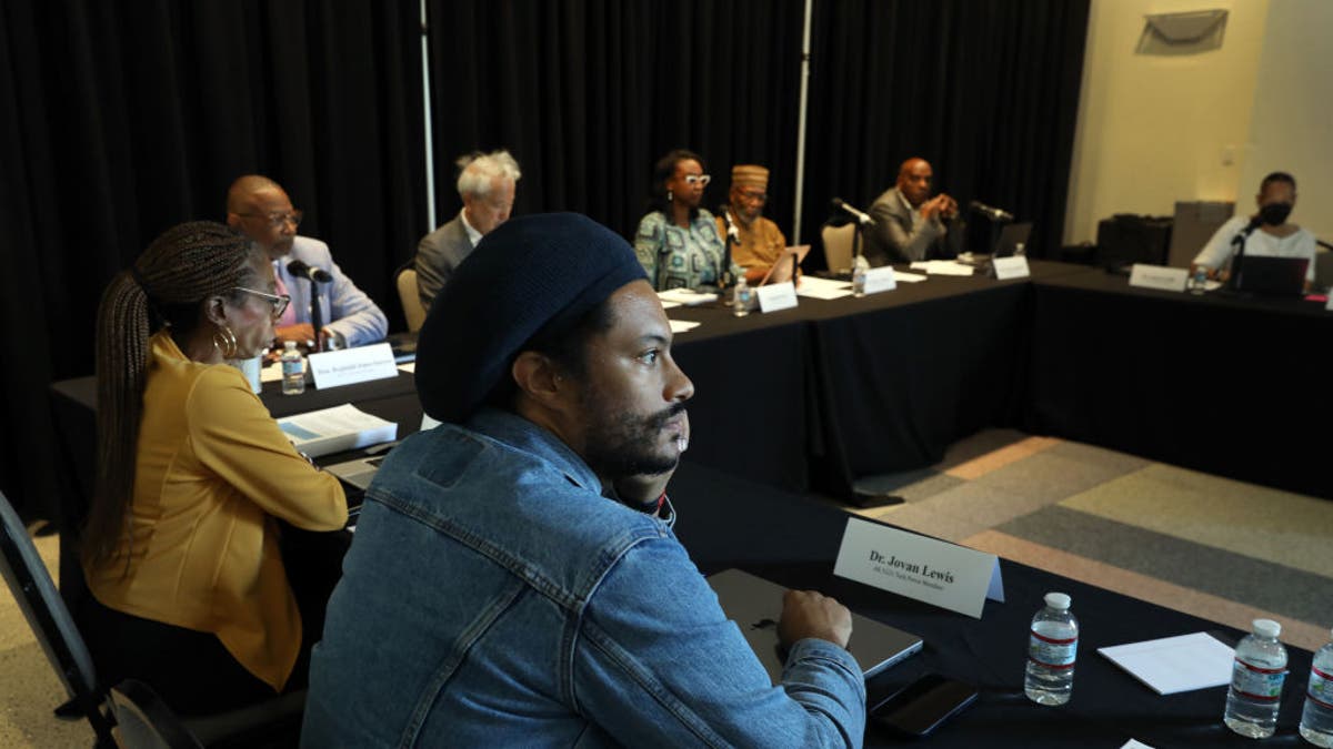 Los Angeles, California-Sept. 22, 2022-Dr. Jovan Lewis, center, listens during as the California Reparations Task Force meets to hear public input on reparations at the California Science Center in Los Angeles on Sept. 22, 2022. (Carolyn Cole / Los Angeles Times via Getty Images)