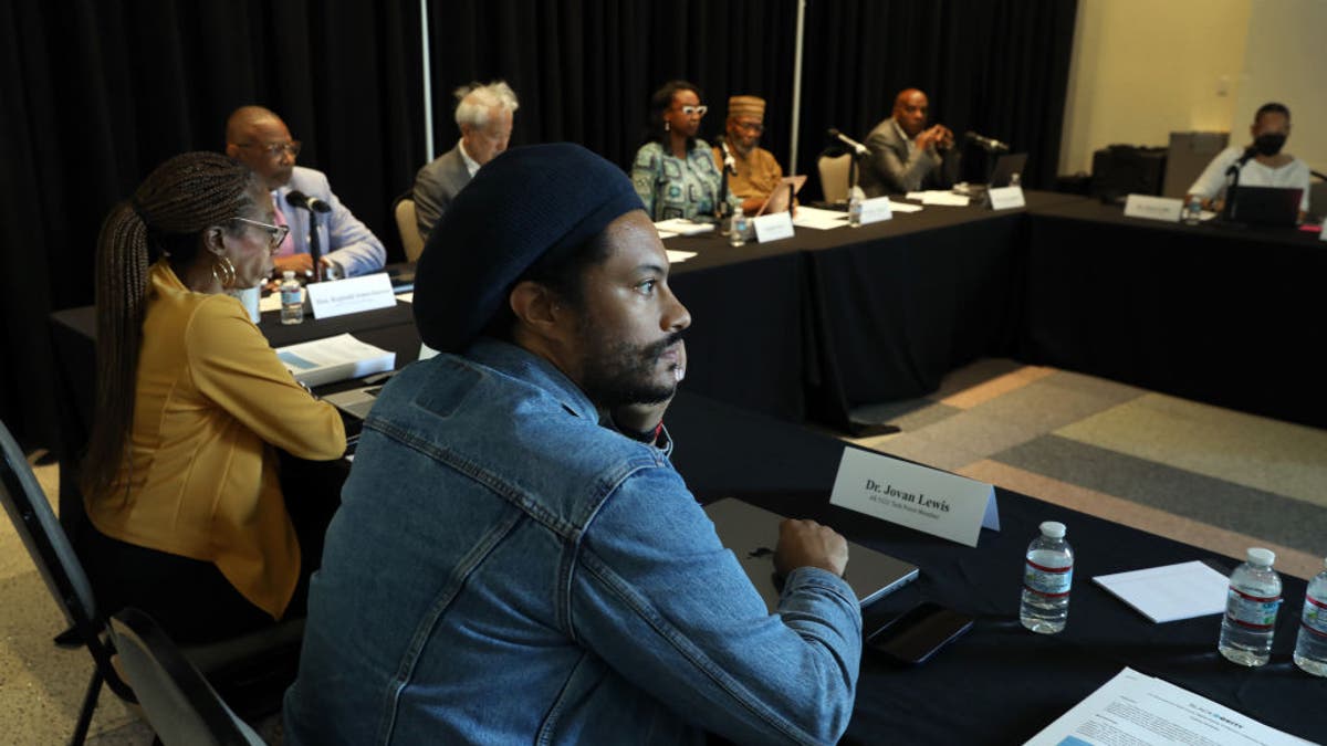 Los Angeles, California-Sept. 22, 2022-Dr. Jovan Lewis, center, listens during as the California Reparations Task Force meets to hear public input on reparations at the California Science Center in Los Angeles on Sept. 22, 2022. (Carolyn Cole / Los Angeles Times via Getty Images)