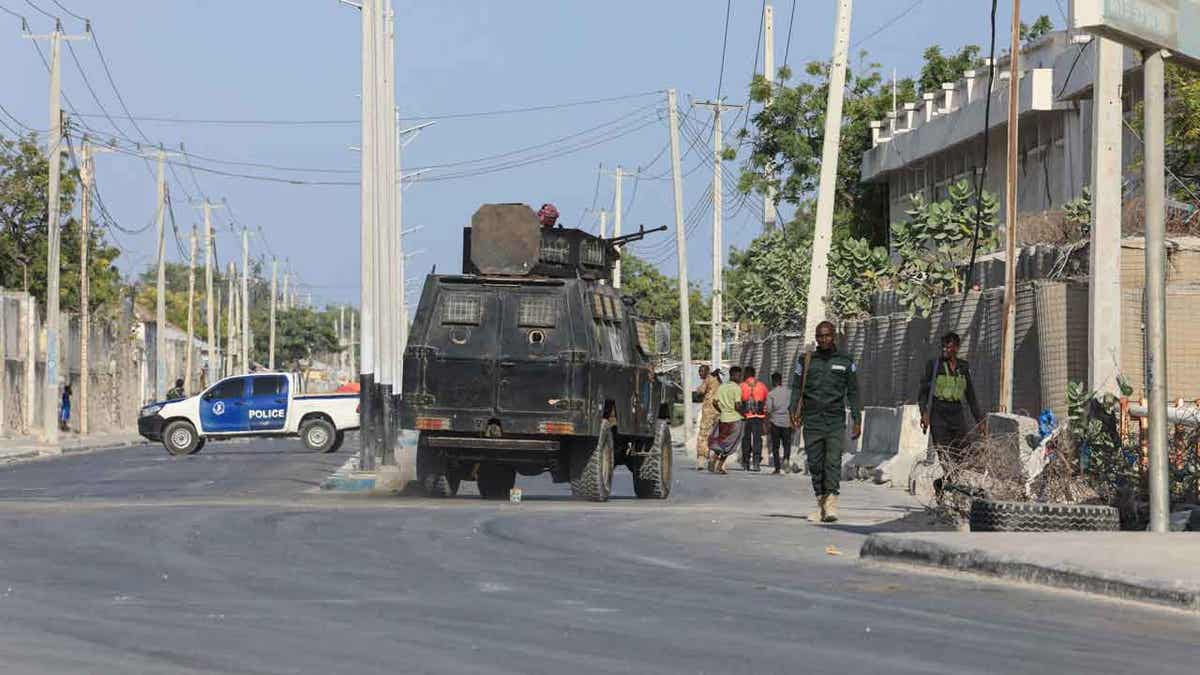 Security forces patrol outside a building 