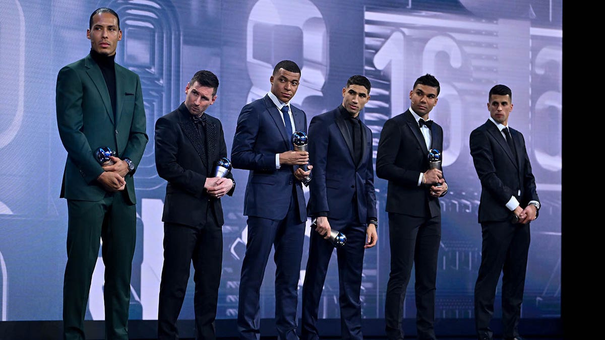 Achraf Hakimi stands on stage for the FIFA Football Awards