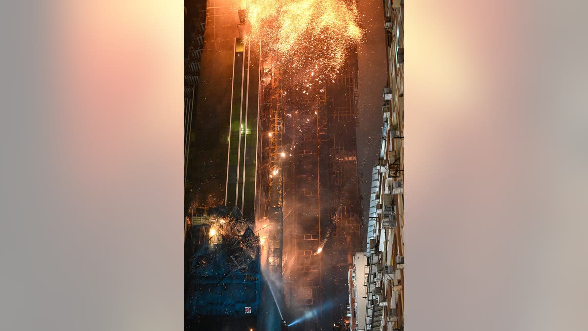 A fire burns at a high-rise building under construction in the Tsim Sha Tsui district in Hong Kong on March 3, 2023.