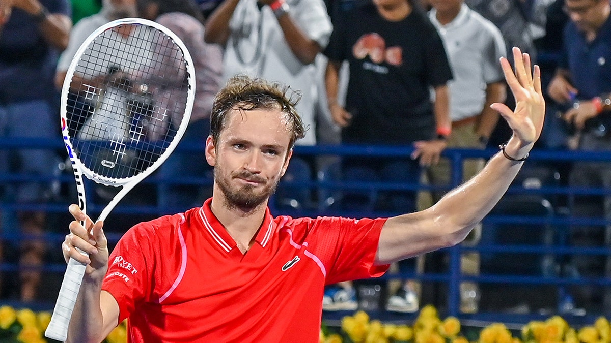 Daniil Medvedev with his hand in the air
