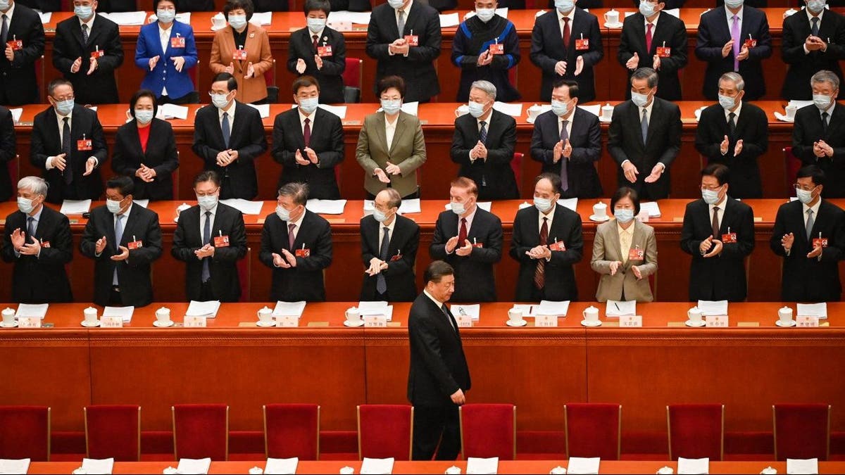 China's President Xi Jinping (bottom) arrives for the second plenary session of the National People's Congress (NPC) with other Chinese leaders at the Great Hall of the People in Beijing on March 7, 2023.