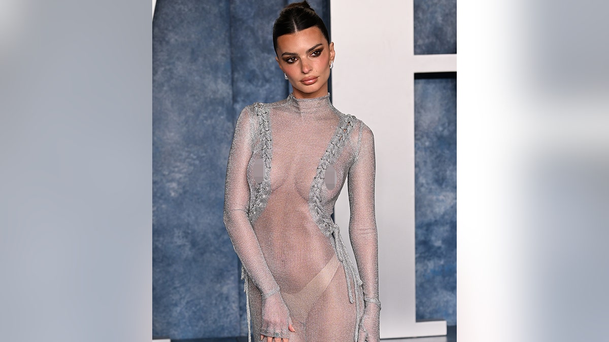 Emily Ratajkowski poses in a sheer dress showing off her tan underwear on the Vanity Fair Oscar red carpet