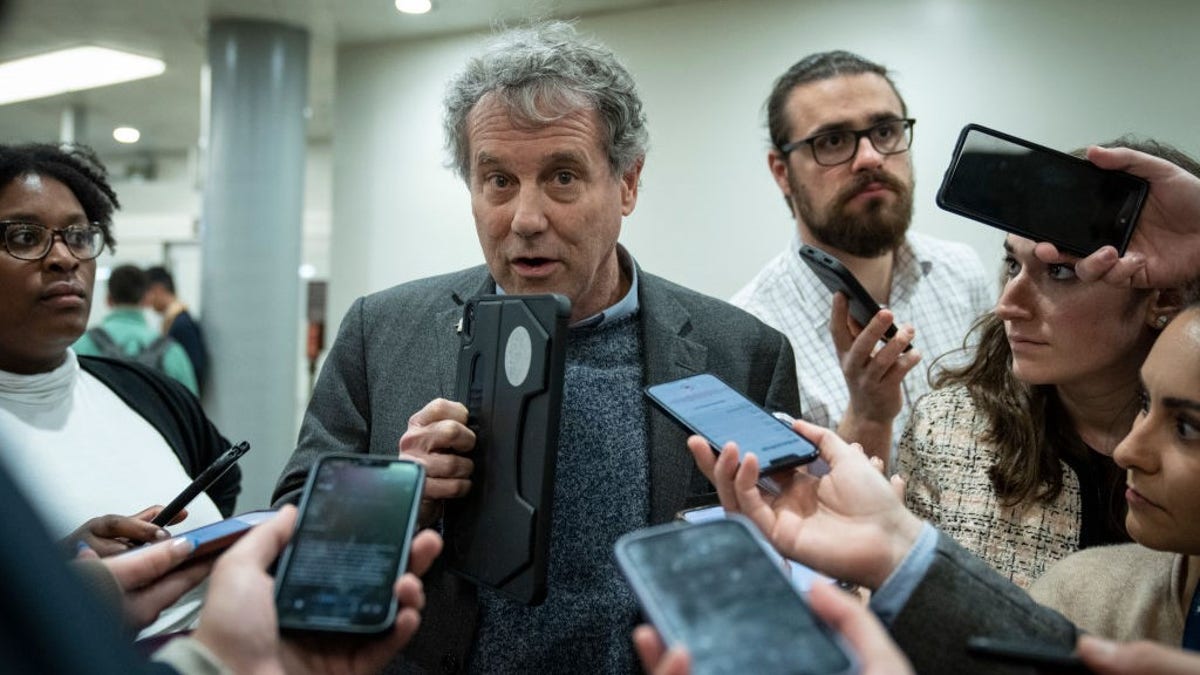 Sen. Sherrod Brown, D-Ohio, speaks to reporters in the Senate subway on his way to a vote at the U.S. Capitol March 14, 2023 in Washington, D.C.