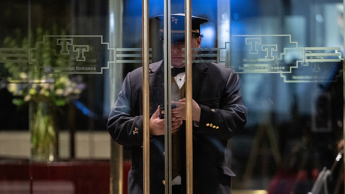 A guard behind a door