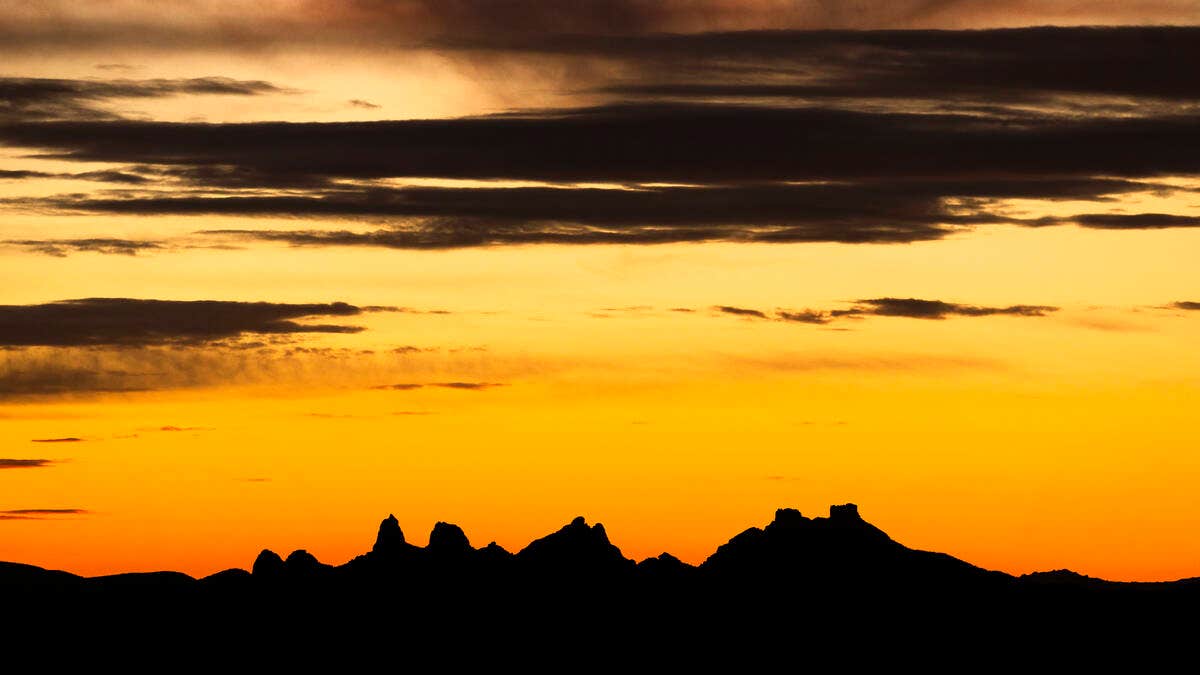 The sun sets beyond the Castle Mountains within Avi Kwa Ame on Feb. 13, 2023, in Boulder City, Nevada. President Joe Biden designated the area a national monument on Tuesday, March 21, 2023. (L.E. Baskow/Las Vegas Review-Journal/Tribune News Service via Getty Images)