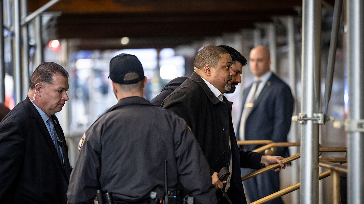 Manhattan DA enters building