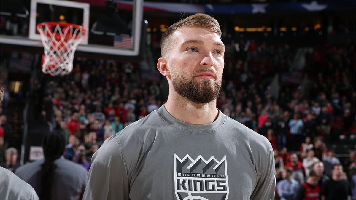 Domantas Sabonis looks on before a game in Portland