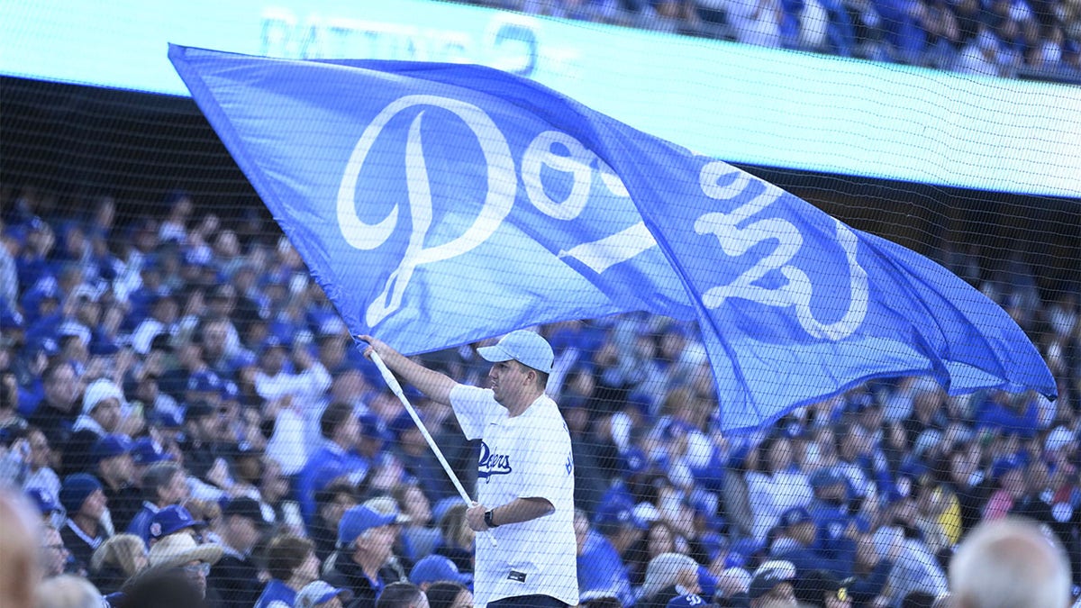A Dodgers flag is flown on Opening Day