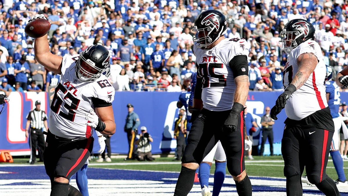 Chris Lindstrom spikes the ball after a touchdown vs the Giants