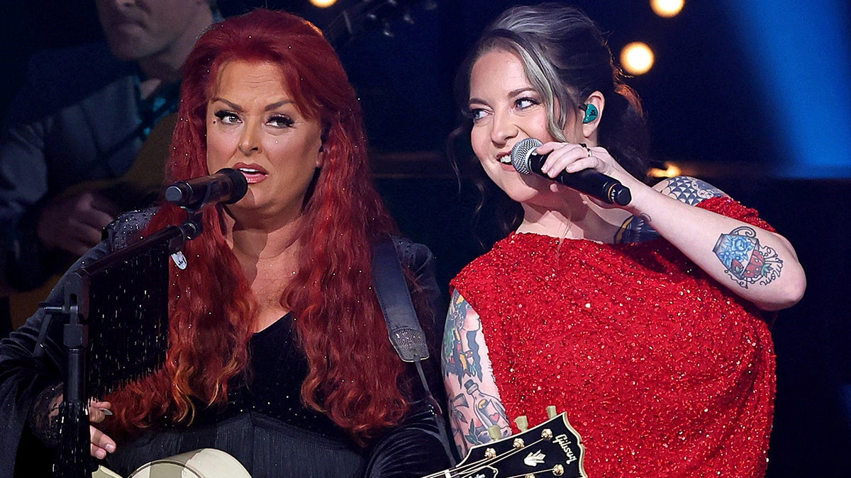 Ashley McBryde and Wynonna Judd performing on stage together