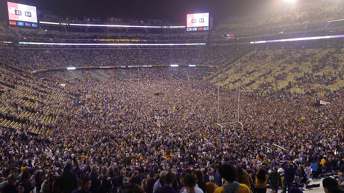 LSU fans storm the field after a win over Alabama