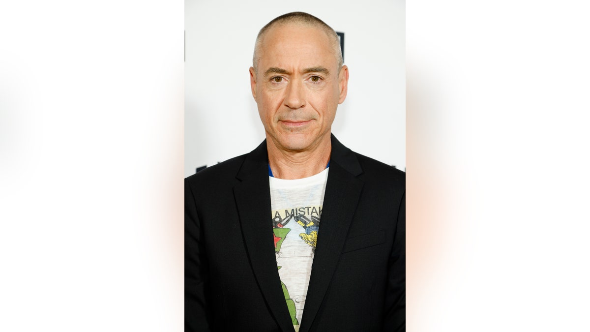 Robert Downey Jr poses with shaved head on the red carpet