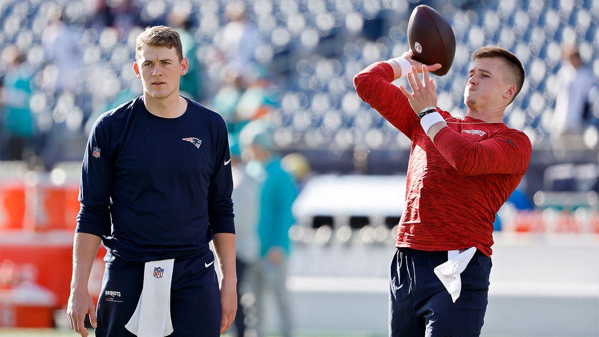 Bailey Zappe and Mac Jones warmup before a game