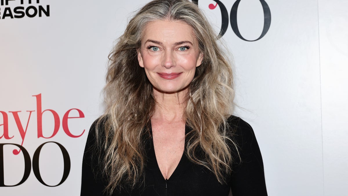 Paulina Porizkova wearing a black top and smiling