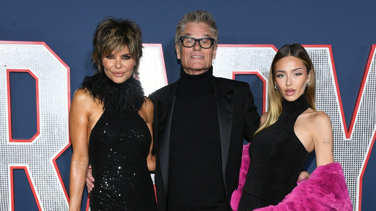 Lisa Rinna in black dress, Harry Hamlin in black suit and Deliliah Belle Hamling in black dress with pink ruffle pose together