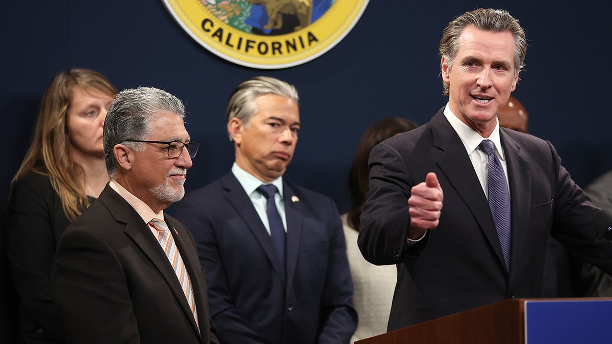 Gavin Newsom at podium with Rob Bonta behind him