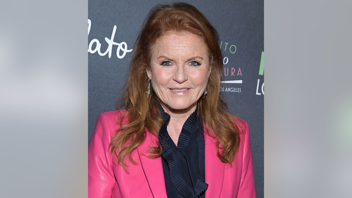 Sarah Ferguson in a hot pink suit and black top smiles on the red carpet in Los Angeles