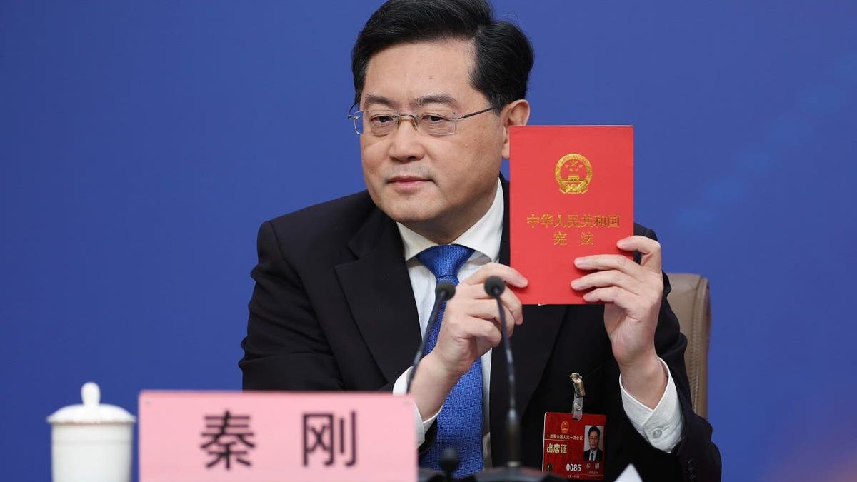 China's foreign minister Qin Gang holds a China's constitution during a press conference at Media Center on March 7, 2023, in Beijing.