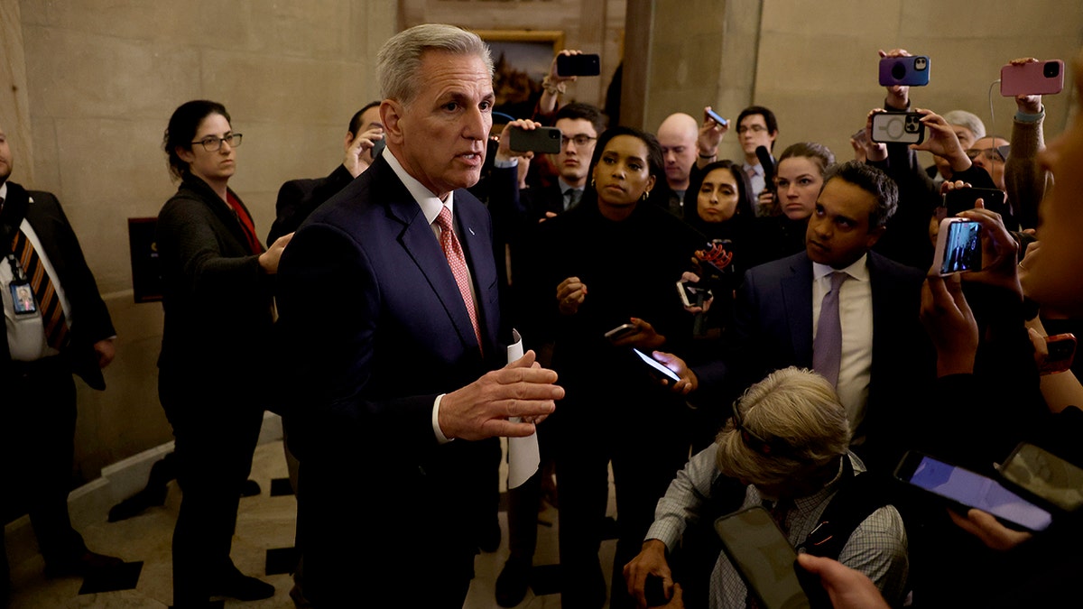 McCarthy surrounded by reporters