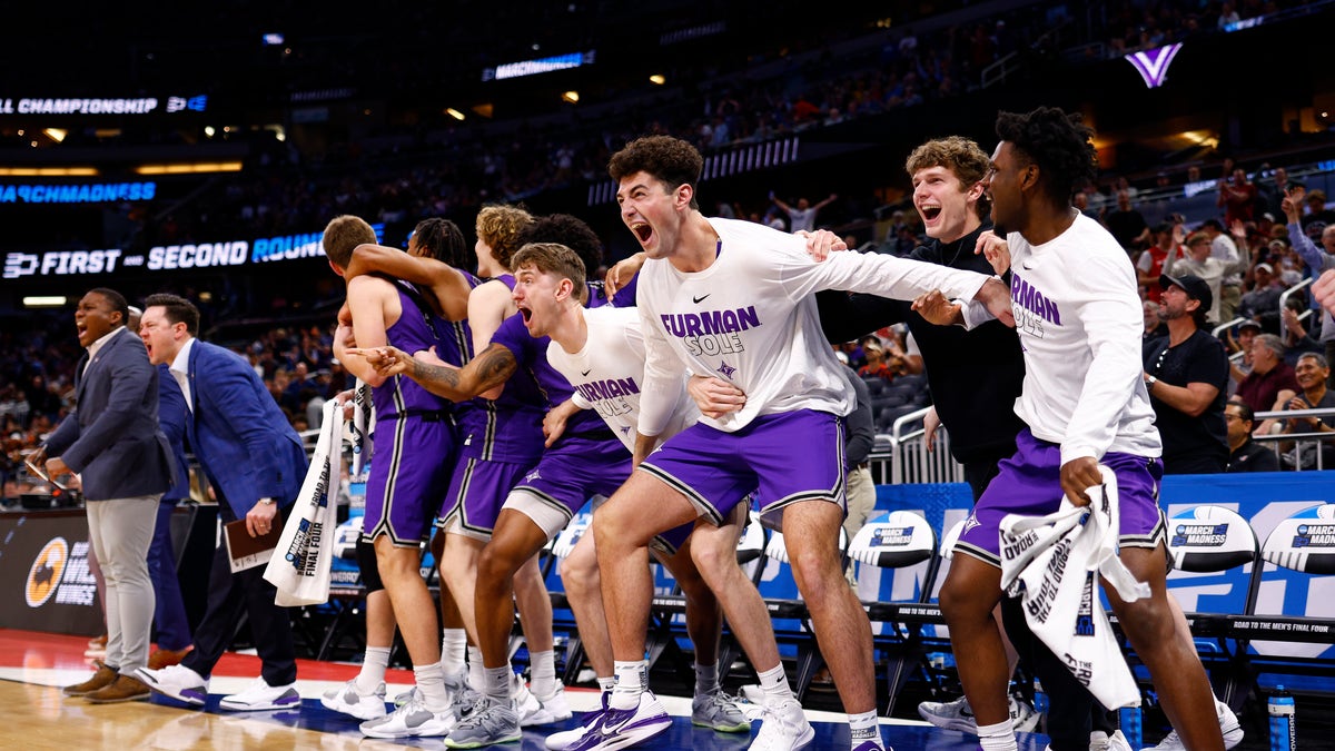 The Furman Paladins bench reacts