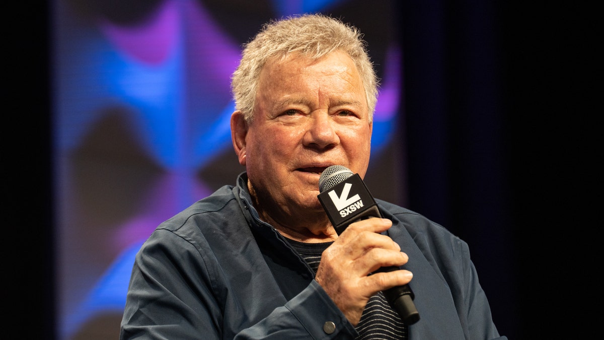 William Shatner speaking into a microphone