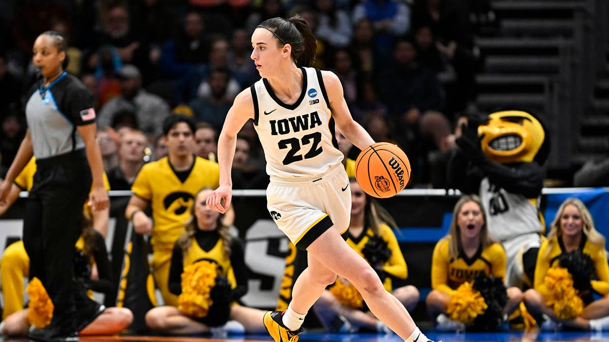 Caitlin Clark dribbles in a game against Louisville