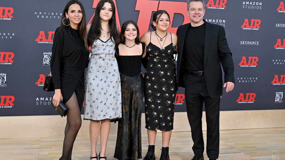 Luciana Barroso, Matt Damon, and three of their daughters pose in coordinating black ensembles on the carpet