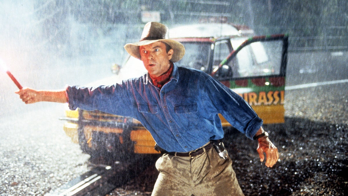 Sam Neill holding a flare in Jurassic Park