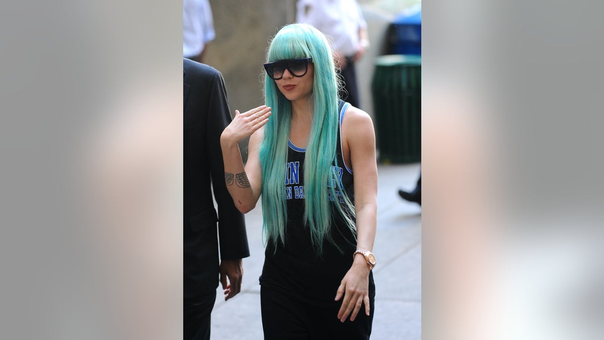 Amanda Bynes in a blue wig and sunglasses outside of court.
