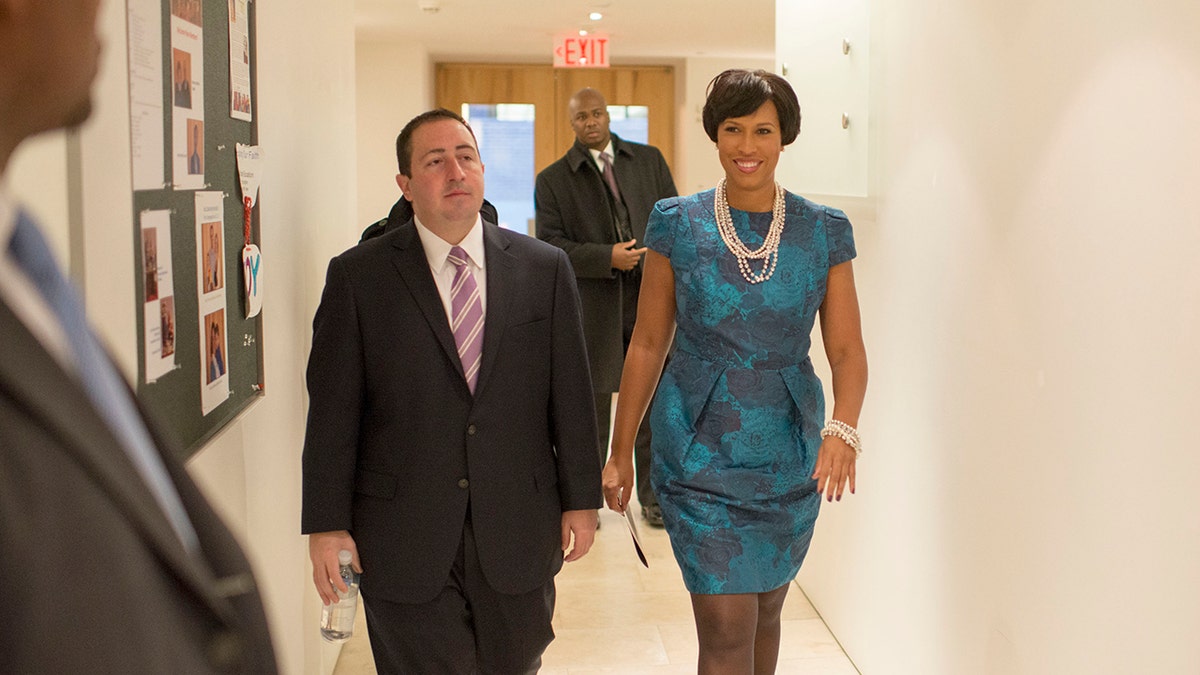 Bowser and John Falcicchio walk down hallway in 2015
